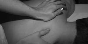 A man being massaged by a masseuse