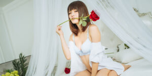 Asian massage therapist with a rose in her mouth